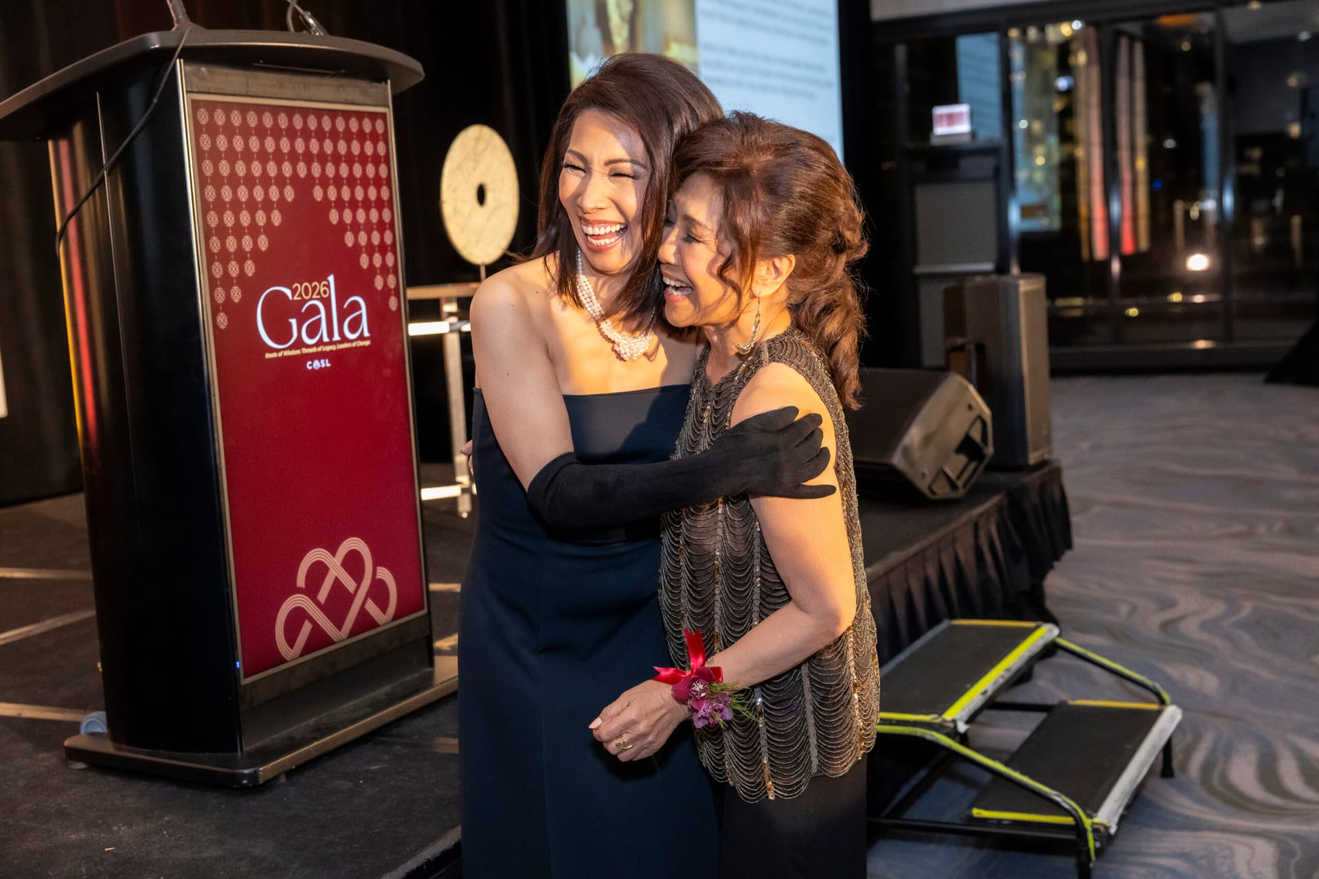 Judy Hsu and Linda Yu laughing and hugging